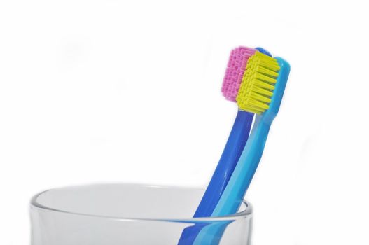 Colorful toothbrushes in a glass