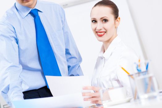 colleagues discuss the reports at a desk in the office, working together in business