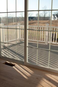 Modern home interior with sliding glass doors leading to a small porch.