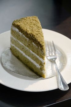 Matcha green tea cake in white dish