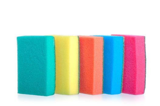 colorful sponges for washing dishes stand in a row on a white background