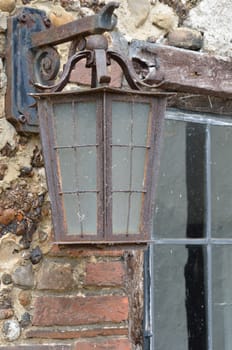 Rusty old lamp on wall