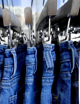 close  up of jeans on a rack