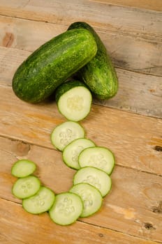 Fresh cucumber arranged on a rustic wooden table