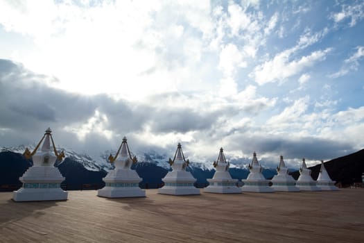 White pagodas Tibet with mountain and blue sky