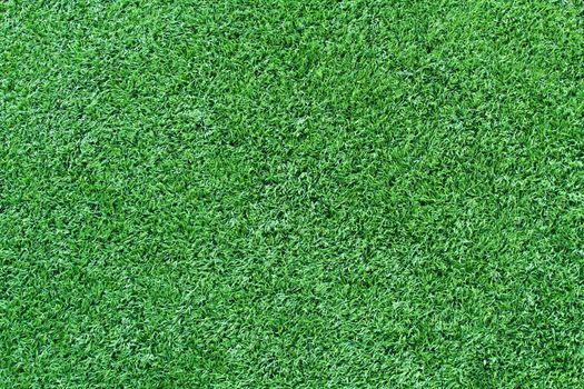Green artificial grass soccer field for background