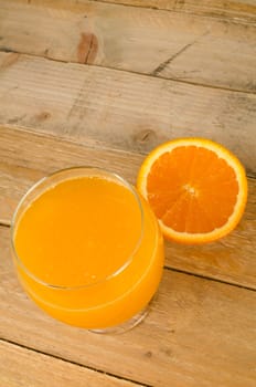 Orange juice against an old wood background