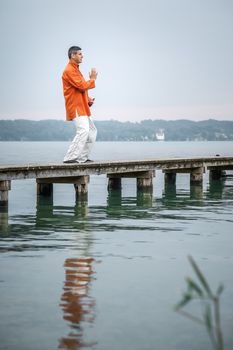 A man doing Qi-Gong in the early morning at the lake Starnberg