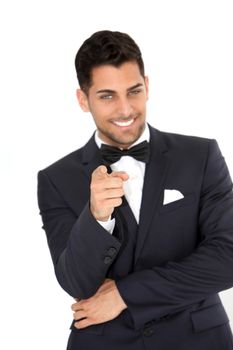 Portrait of smiling young groom pointing at you over the white background