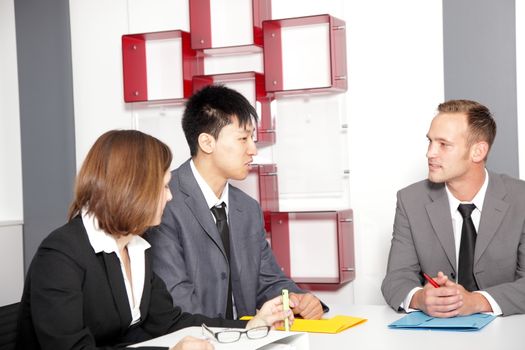 Male executive discussing with his colleagues during a meeting