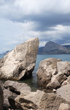 Summer landscape with big stones on shore near sea