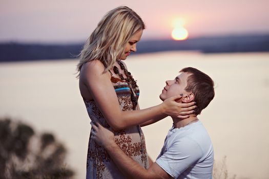 Man makes a marriage proposal at sunset