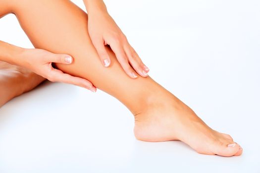 Female legs and hands, white background