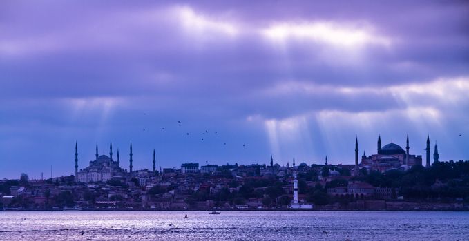 Dramatic stormy sky over  Istanbul city with Blue Mosque and Hagia Sophia in Sultan Ahmed nighborhood. Istanbul, Turkey.