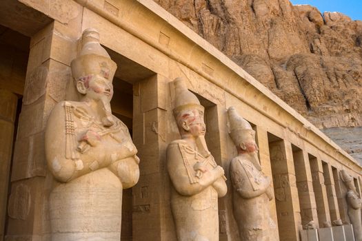 A row of statues of Queen Hatshepsut as Osiris, the god of the dead, at her temple in Luxor (Thebes), Egypt.