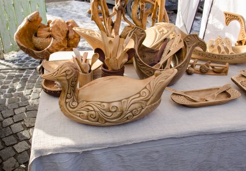 handmade carved diy wooden kitchen tools utensils and bird decorations dish sale in market fair.