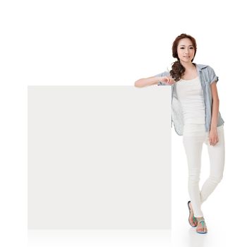 Attractive Asian woman lean on blank board of advertisement on white background.