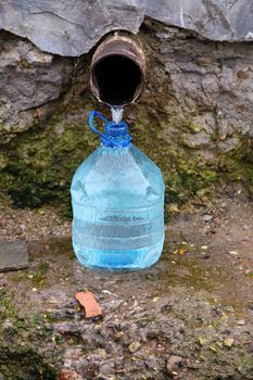 Natural source of water and plastic bottle