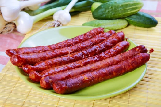 Still-life with fried sausages garlic and cucumbers