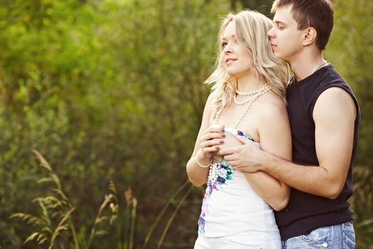 Man and woman embracing and looking into the distance