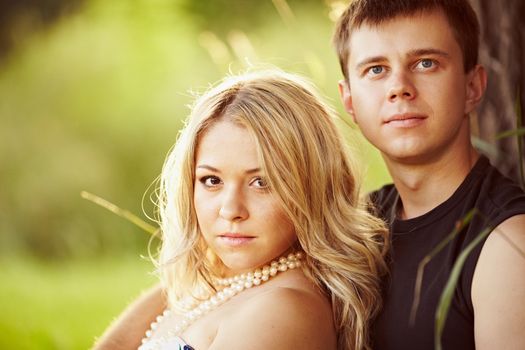 Young guy with a girl under the tree.