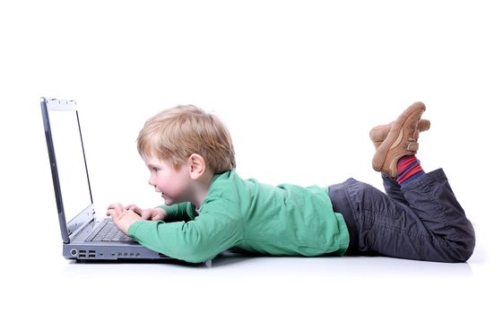 young boy using a laptop lay down isolated on white backgound