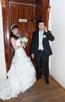 Bride and groom standing in front of the door