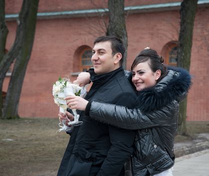 bride embraces the groom on the street