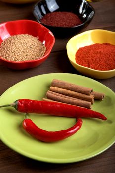 Plates with spices on an old wooden table