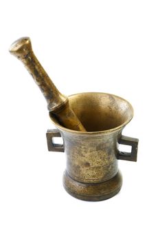 Brass mortar with a pestle isolated on a white background