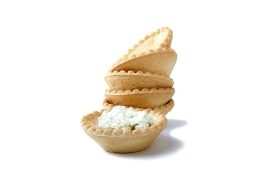 Tartlets with soft cheese isolated on a white background