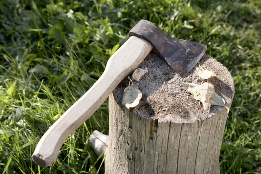 Axe with  pack for cabin against a green grass