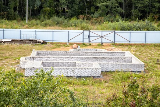 Building site with the base of the house from a brick