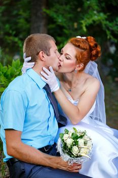 Passionate Wedding Kiss in a Summer City Park