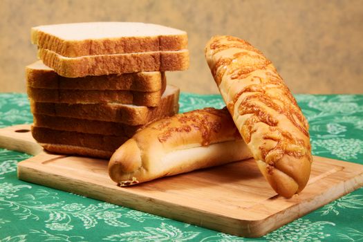 Pieces of bread and roll on a kitchen table