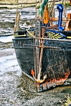 The hull of a boat at low tide on Faversham Creek, Kent UK