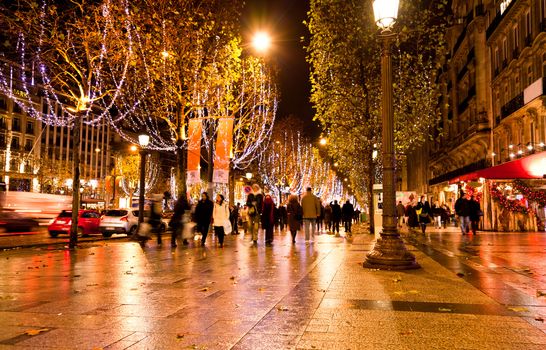 the famous shooping district Champs Elysees illuminated with Christmas light in Paris 