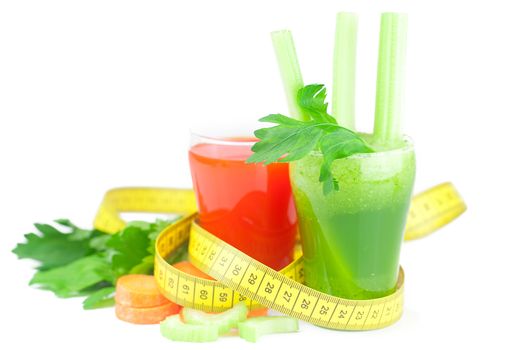 measuring tape, glass of celery juice and glass of carrot juice isolated on white