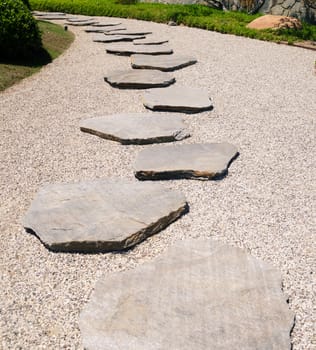 Stone's way in the Japanese garden in sunny day