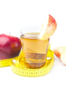 measuring tape,apples and glass of apple juice isolated on white