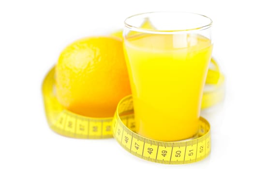 measuring tape,orange and a glass of orange juice isolated on white