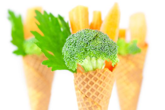 carrot, celery, broccoli in a waffle cone isolated on white