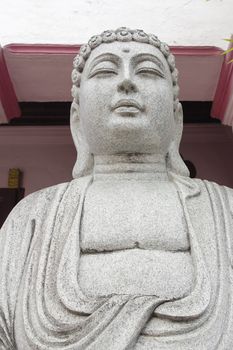 Stone Carved Buddha Sculpture at Temple Exterior Closeup