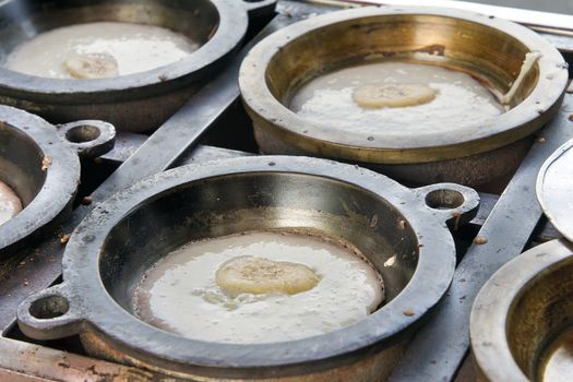 Making of Kueh Apom Balik Turnover Pancake with Banana in Brass Mold Pan at Local Food Hawker Stall in Penang Malaysia