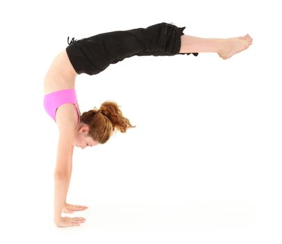 Beautiful strong child in a handstand with legs held out. Clipping path over white.