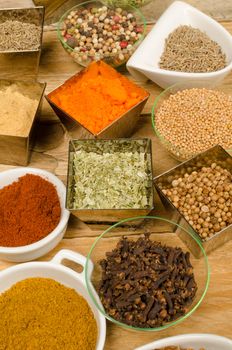 Assorted condiments in small bowls, a food background