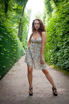 young woman on summer alley in the park