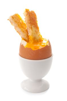 Boiled egg in a cup holder with buttered toasted soldiers 