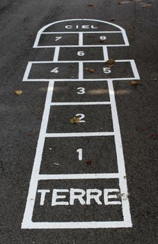 Hopscotch with french words terre (ground) and ciel (sky) on the schoolyard