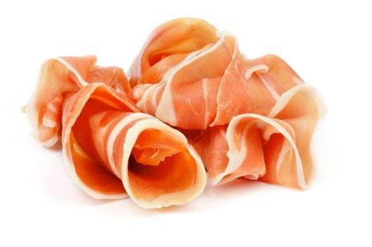 Curled Slices of Delicious Prosciutto isolated on white background